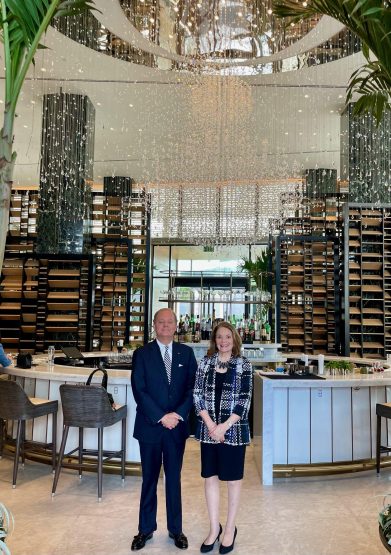 Bret Clesi, Dean of the Consular Corps and Honorary Consul of Albania and the Honorary Consul of Canada Pat Denechaud in front of the Four Seasons Hotel's lobby bar, The Chandelier Bar.
