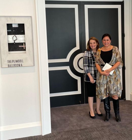 Honorary Consul of Canada Pat Denechaud and Four Seasons Hotel Director of Events Geena Urbina standing in front of The Plimsoll Ballroom, reminiscent of former World Trade Center building's The Plimsoll Club.